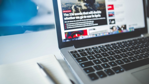 Laptop opened to news site